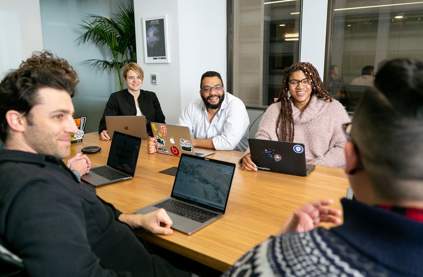 An operations team working together around a conference table